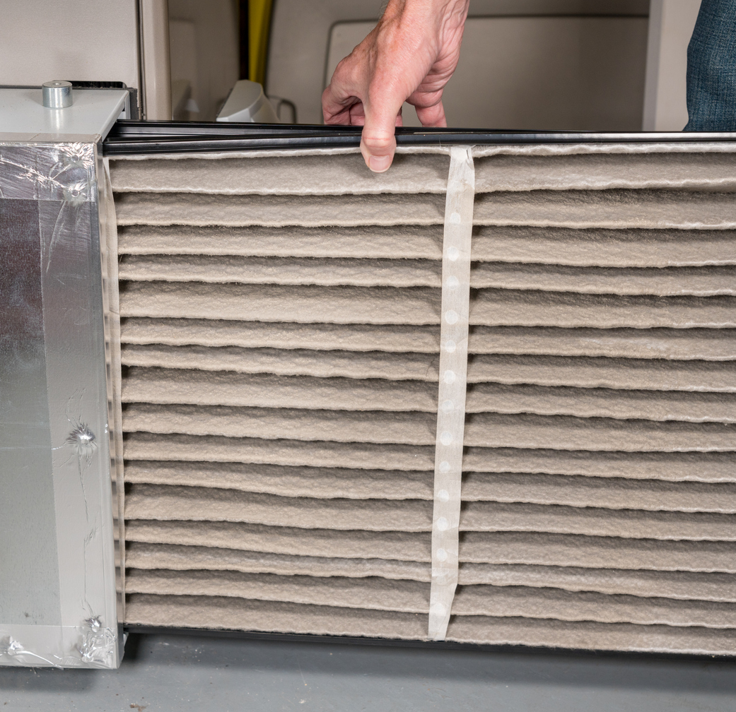 Furnace repairman repairing Gas Furnace