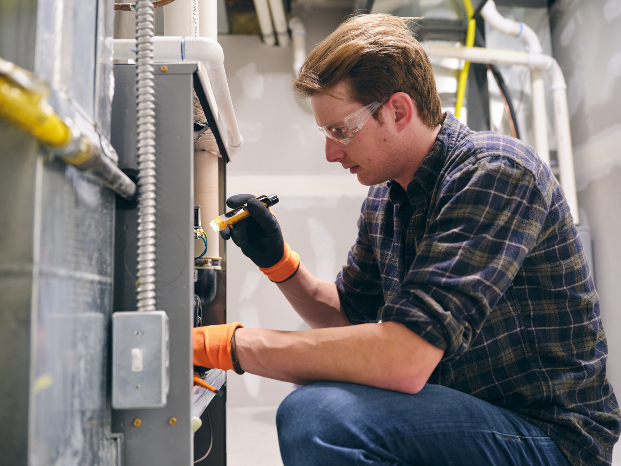 Repairman Working on a Furnace Air Condition Service repair