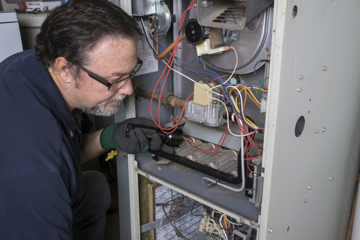 Looking Over A Gas Furnace Air Condition Service repair